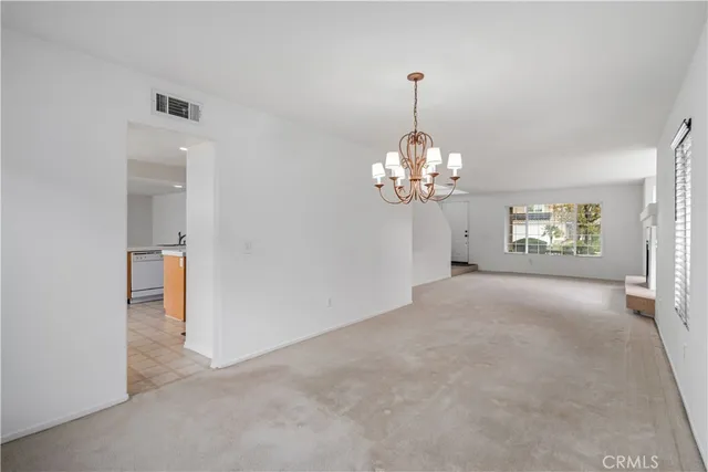 a view of a chandelier in big room and chandelier