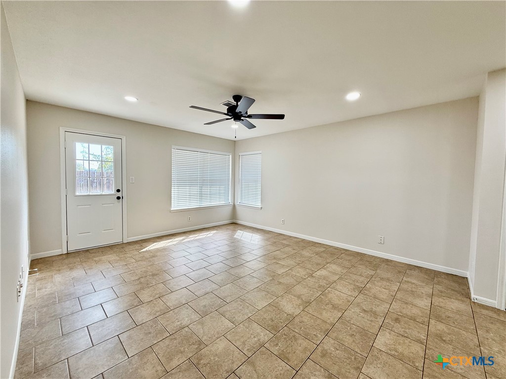 210 Stone Gate Drive Victoria, TX 77904 - Photo 12 of 23 an empty room with windows and ceiling fan