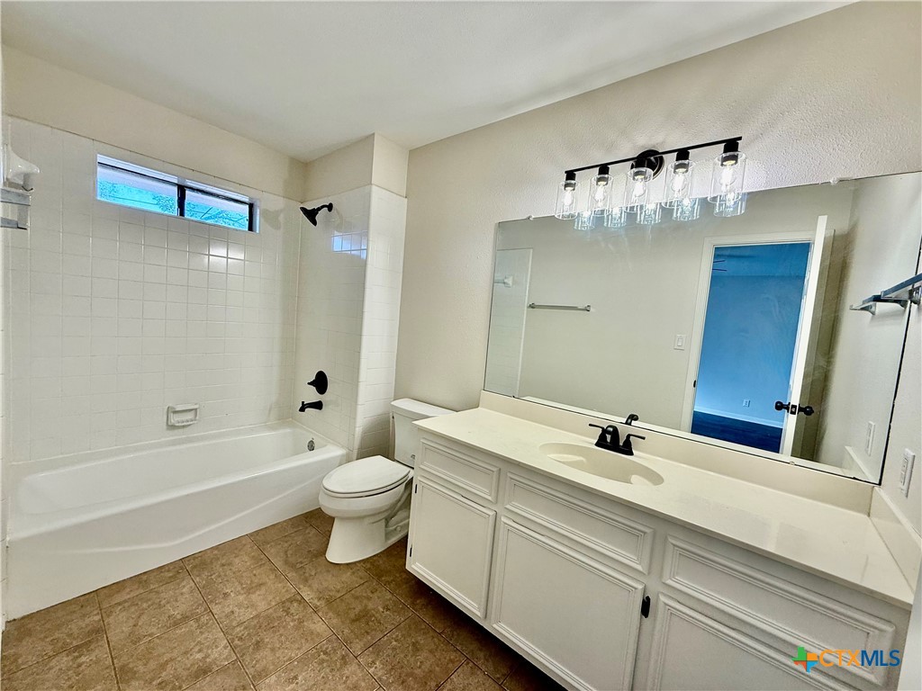 210 Stone Gate Drive Victoria, TX 77904 - Photo 19 of 23 a bathroom with a sink a toilet and shower