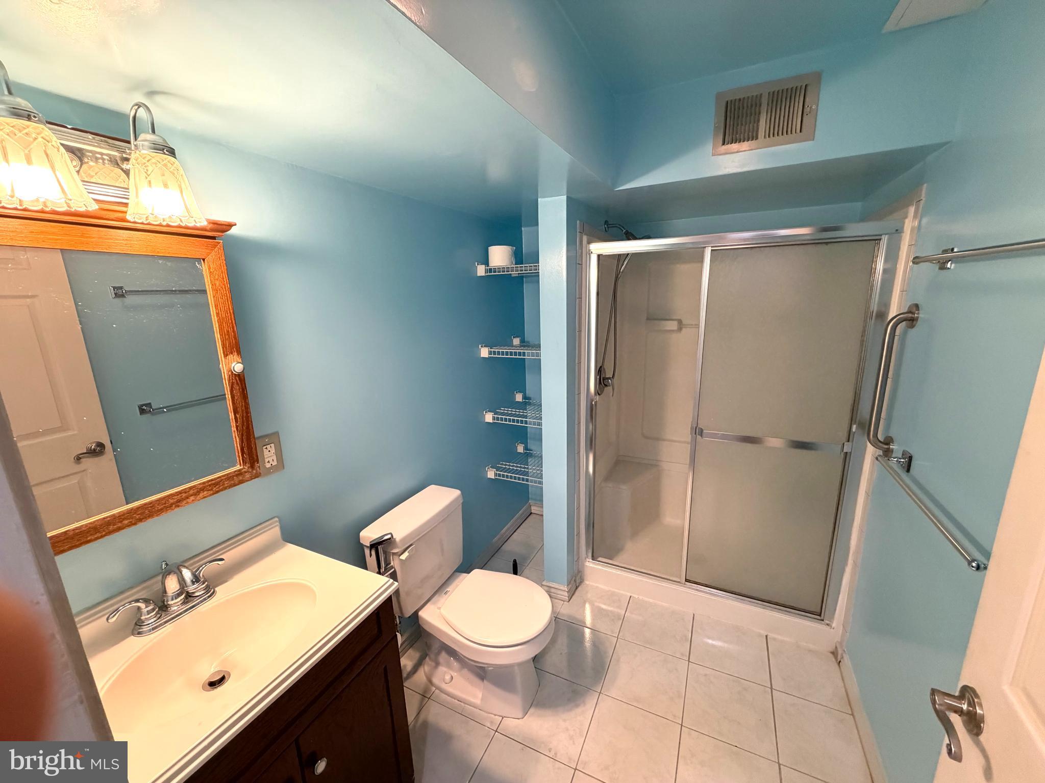 8 Hardwood Drive Rosedale, MD 21237 - Photo 28 of 42 a bathroom with a toilet sink and a mirror