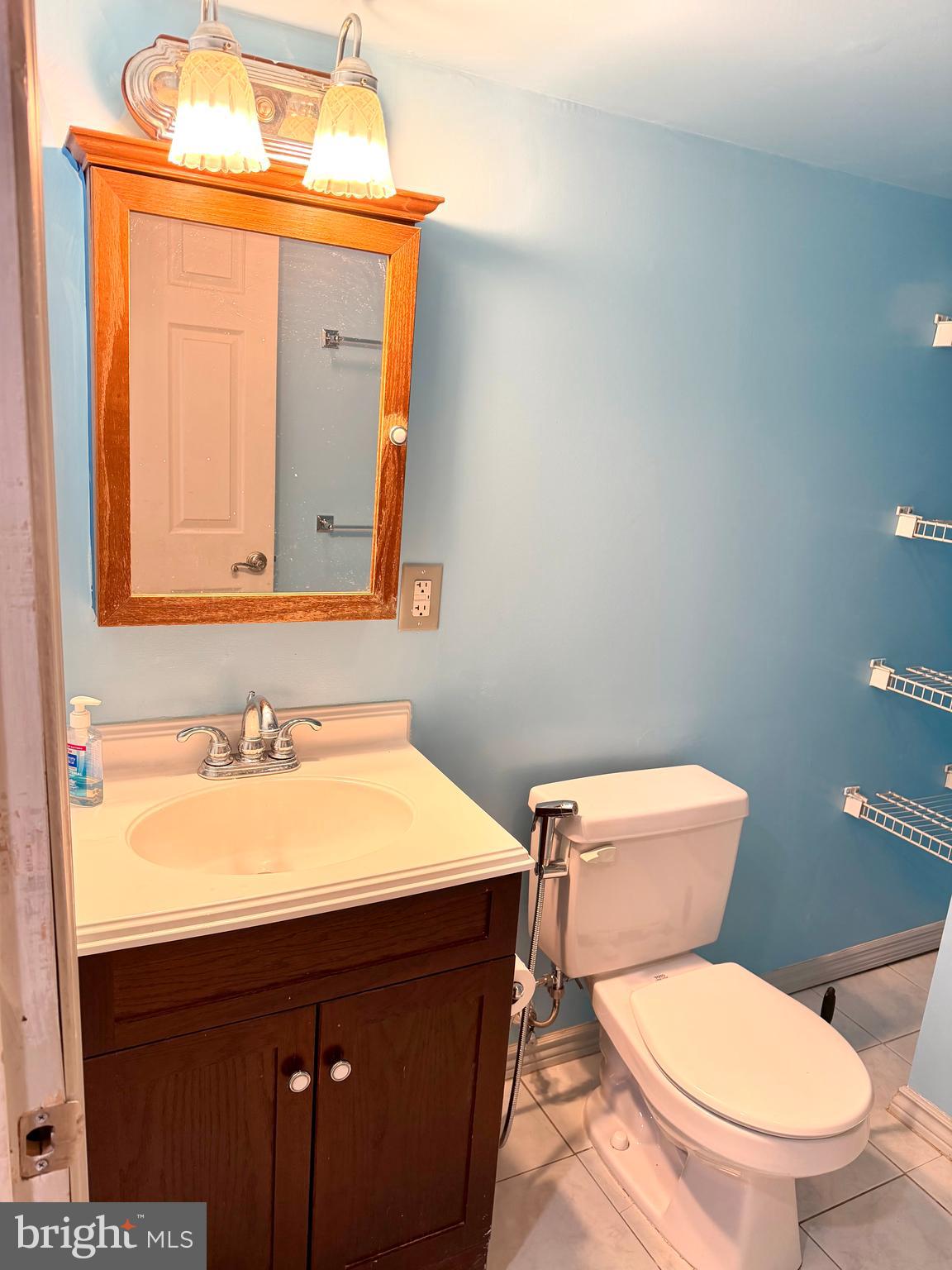 8 Hardwood Drive Rosedale, MD 21237 - Photo 29 of 42 a bathroom with a toilet a sink and mirror