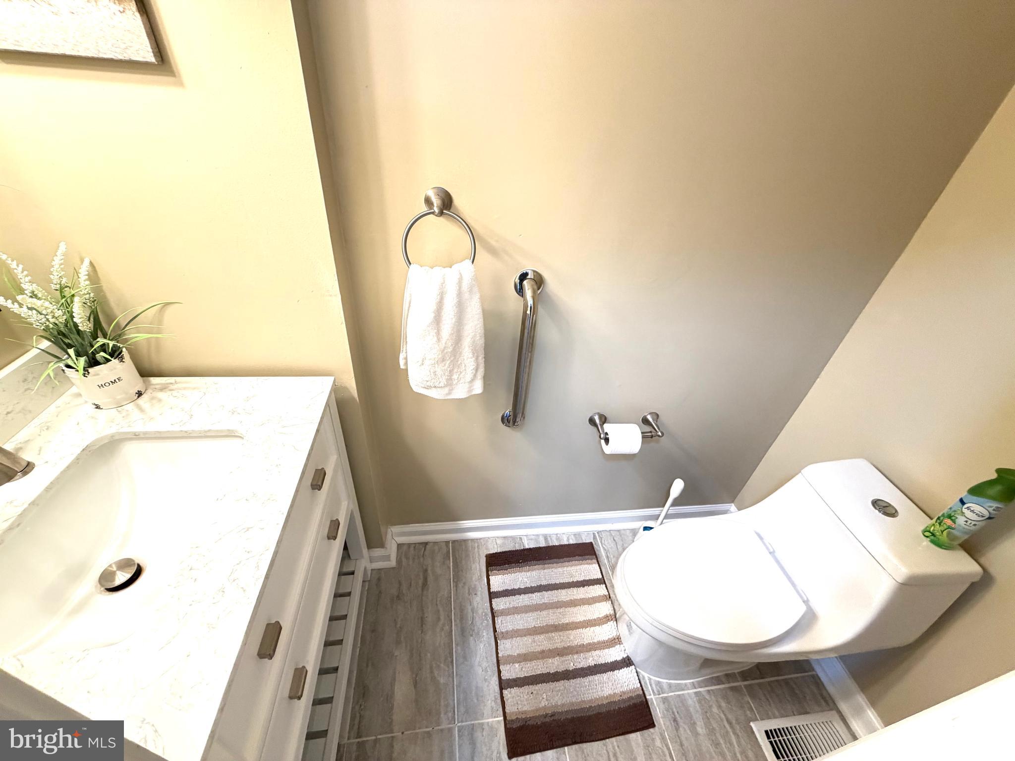 8 Hardwood Drive Rosedale, MD 21237 - Photo 9 of 42 a bathroom with a sink a toilet and mirror