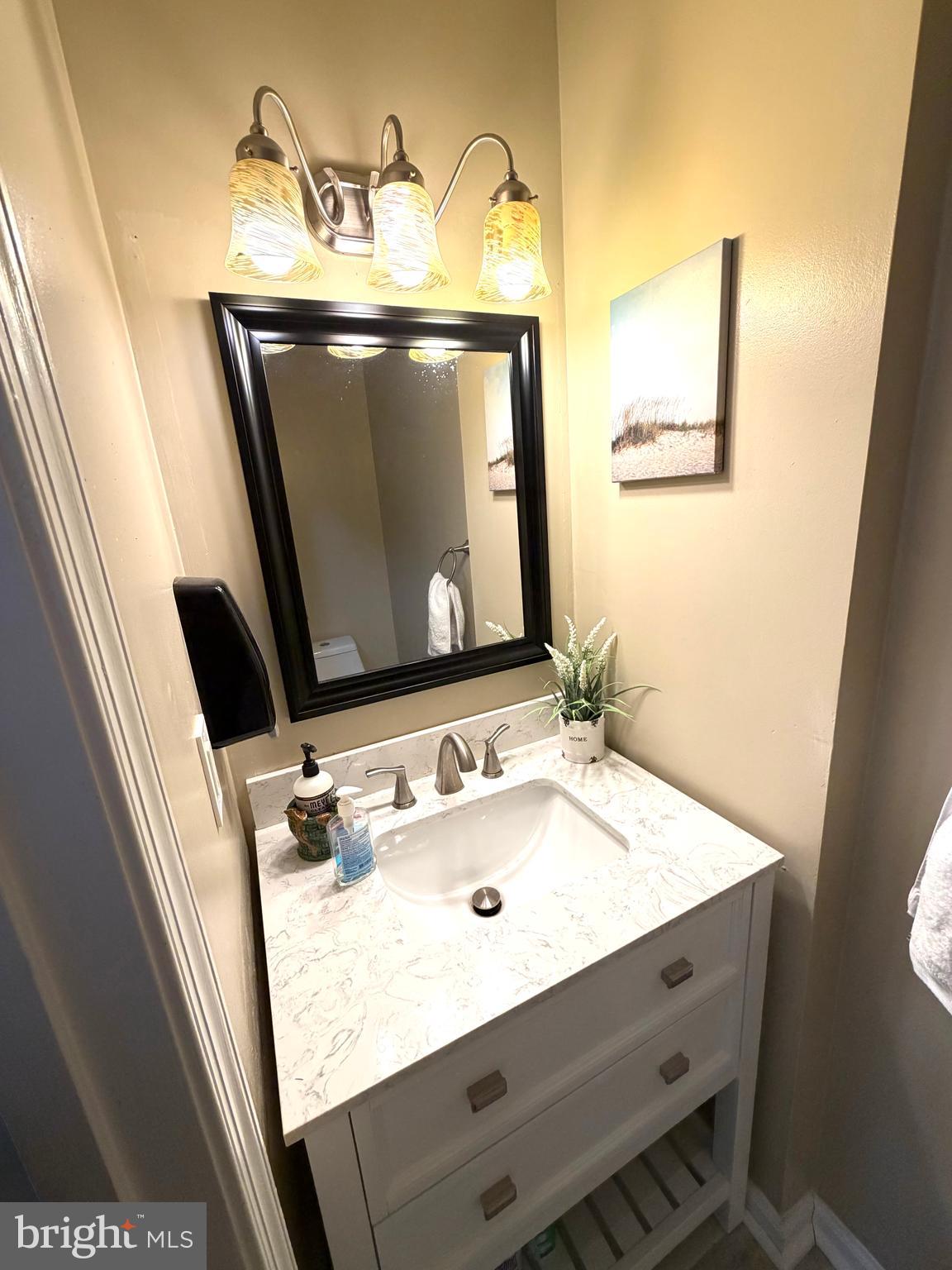 8 Hardwood Drive Rosedale, MD 21237 - Photo 10 of 42 a bathroom with a sink a mirror and vanity