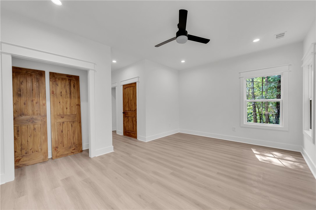 659 White Oak Farms Road Tamassee, SC 29686 - Photo 41 of 50 Natural light pours across smooth hard surface floors into this inviting space with rustic doors.