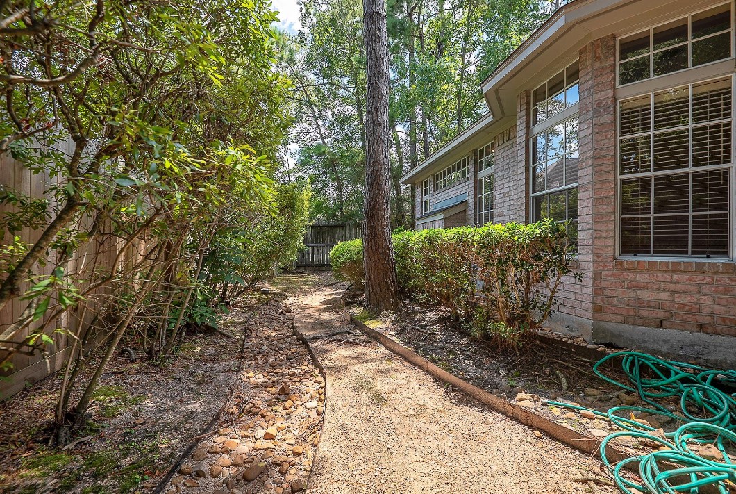 34 Reflection Point The Woodlands, TX 77381 - Photo 40 of 42 Pathway down the side of the house