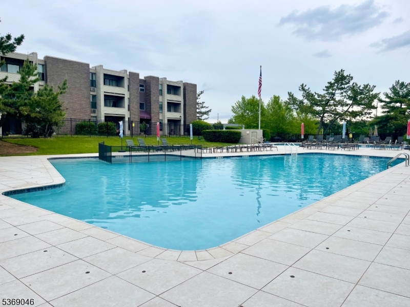 21 River Road, Unit G Nutley, NJ 07110 - Photo 17 of 22 a view of a swimming pool with a garden