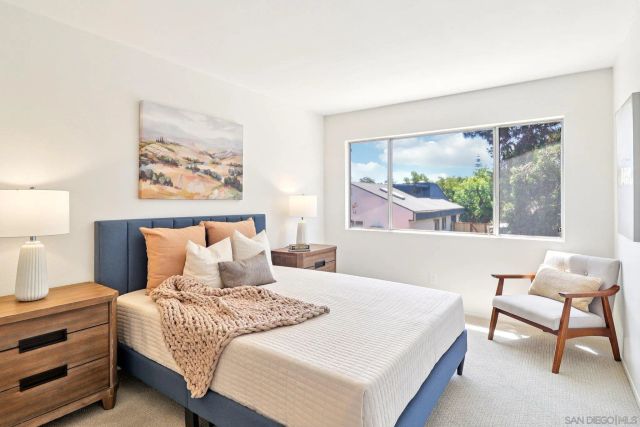 a bedroom with a large bed and a window