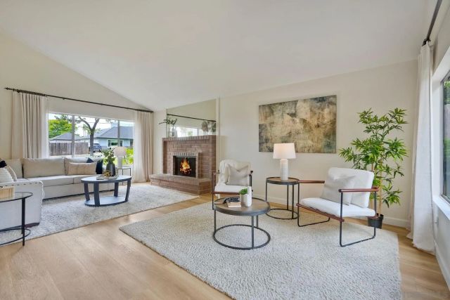 a living room with furniture a dining table and a potted plant