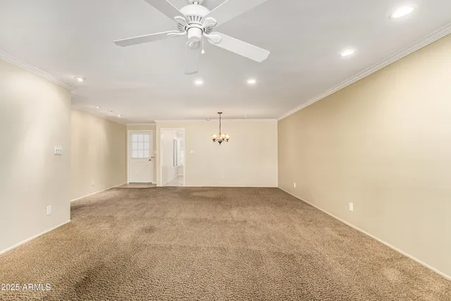 an empty room with a ceiling fan and a window