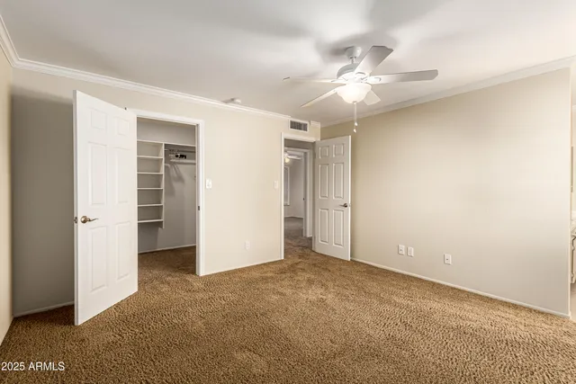 a view of an empty room with a ceiling fan