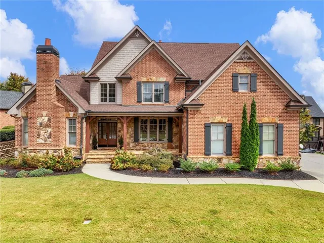 a front view of a house with a yard table and chairs