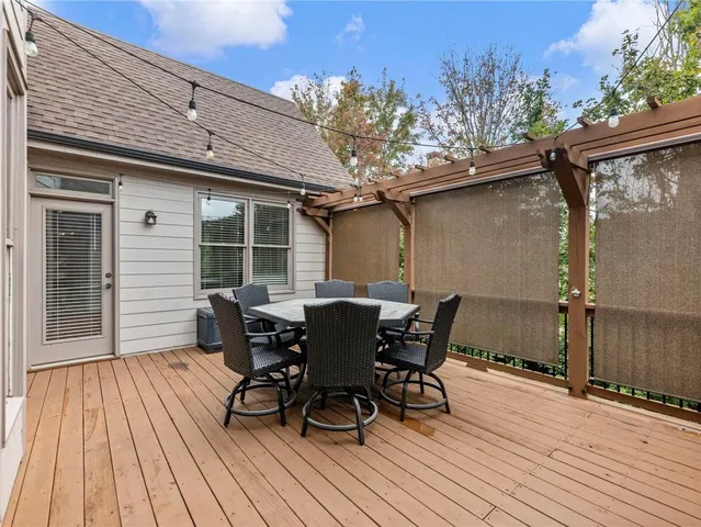 an empty room with wooden floor and ceiling fan