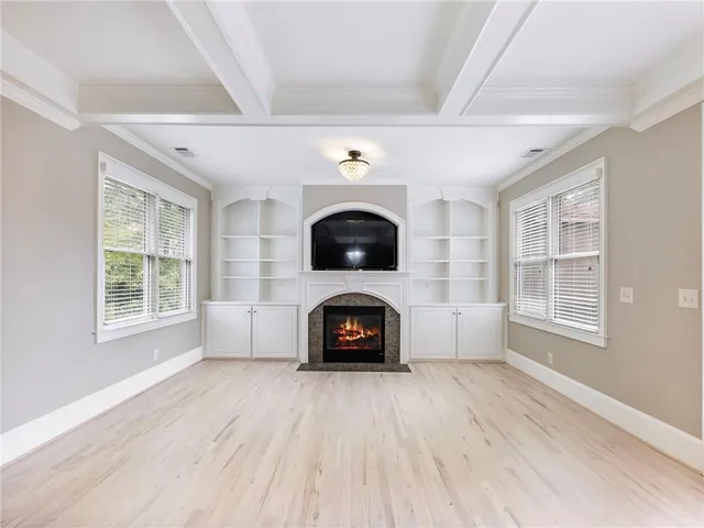 a view of a livingroom with a flat screen tv and ceiling fan