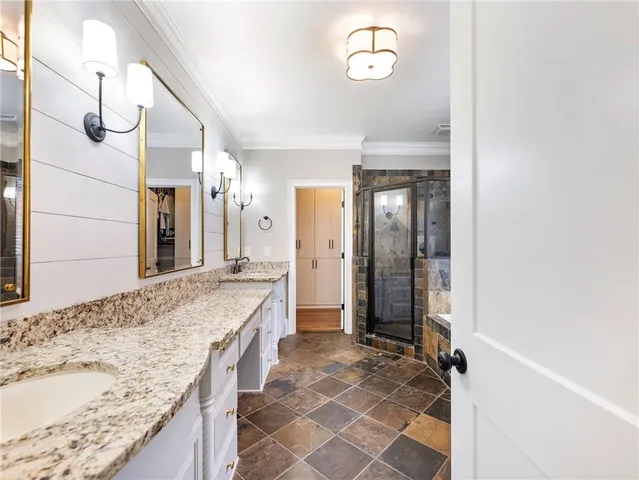 a view of a kitchen with kitchen island stainless steel appliances a sink and wooden floor