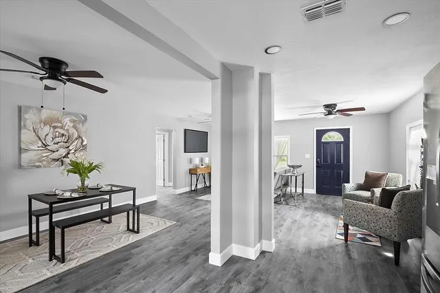 a living room with furniture and wooden floor