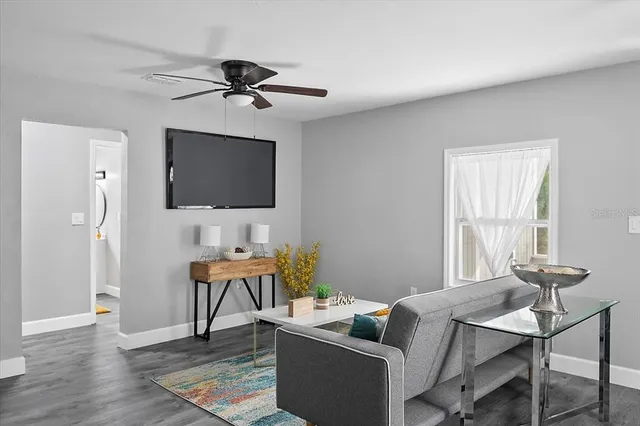a work room with furniture wooden floor and a window