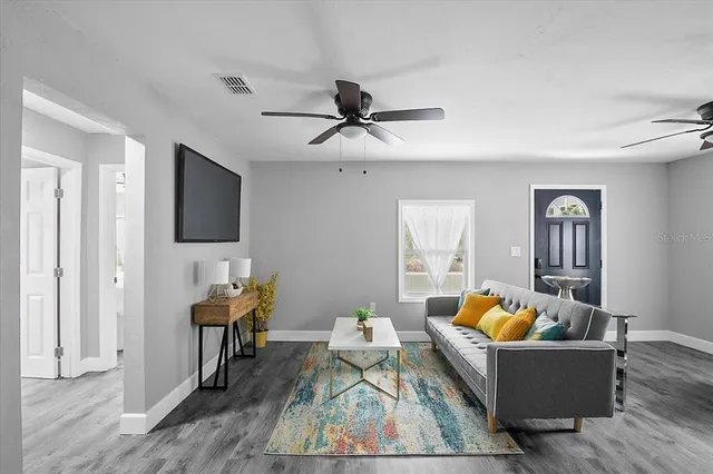 a living room with furniture and a flat screen tv