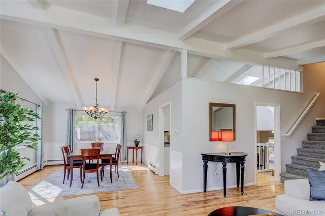 a dining room with furniture and wooden floor