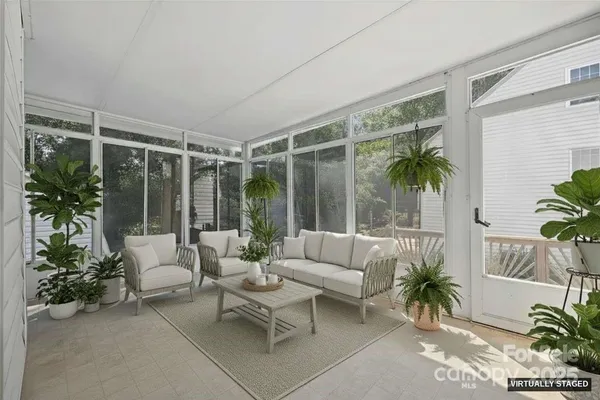 a living room with furniture and a potted plant