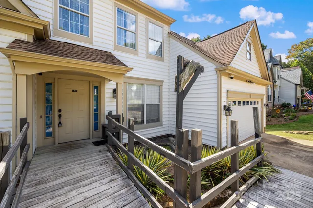 a view of a balcony with two chairs and wooden floor