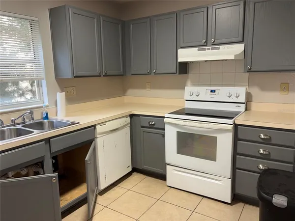 a kitchen with a stove cabinets and sink