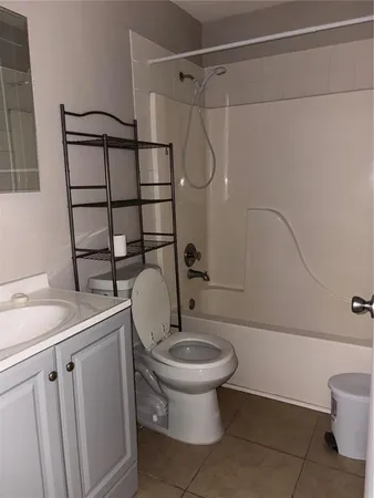 a bathroom with a granite countertop toilet sink and shower