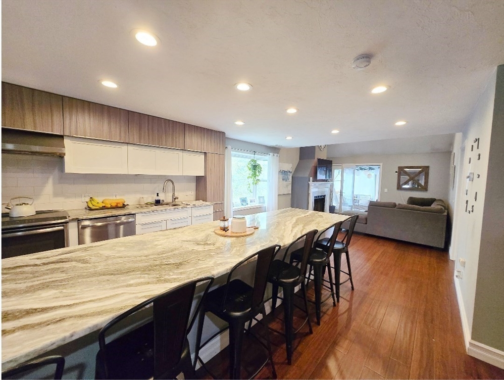 1559 Bay Street, Unit 53 Taunton, MA 02780 - Photo 1 of 40 a kitchen with stainless steel appliances granite countertop a table chairs sink and cabinets