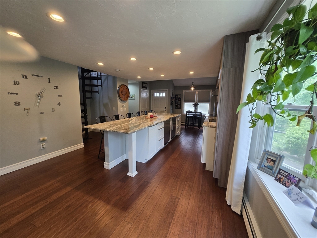 1559 Bay Street, Unit 53 Taunton, MA 02780 - Photo 14 of 40 a large kitchen with stainless steel appliances kitchen island a large counter top space a sink and wooden floor