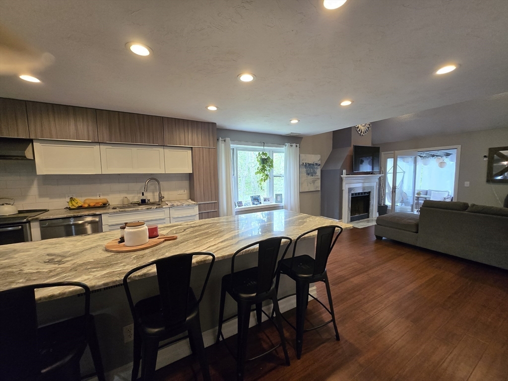 1559 Bay Street, Unit 53 Taunton, MA 02780 - Photo 16 of 40 a kitchen with a table chairs sink and cabinets