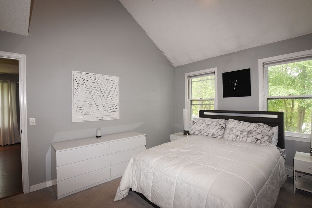 1559 Bay Street, Unit 53 Taunton, MA 02780 - Photo 22 of 40 a bedroom with a bed and a flat tv screen on dresser