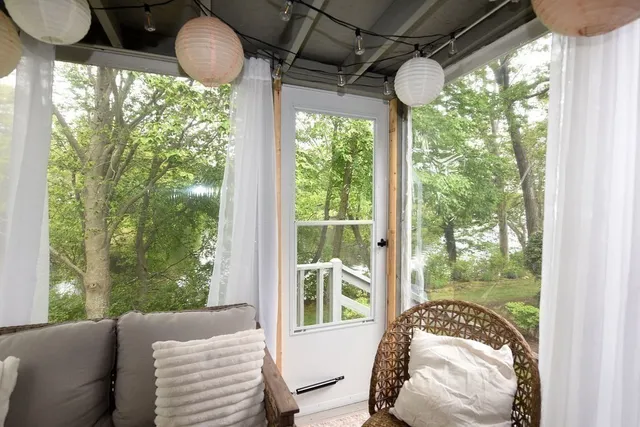 a bedroom with furniture and a large window
