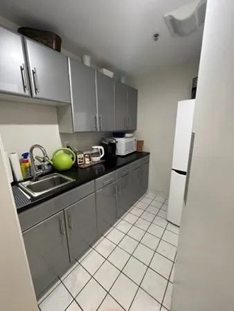 a kitchen with a sink and cabinets