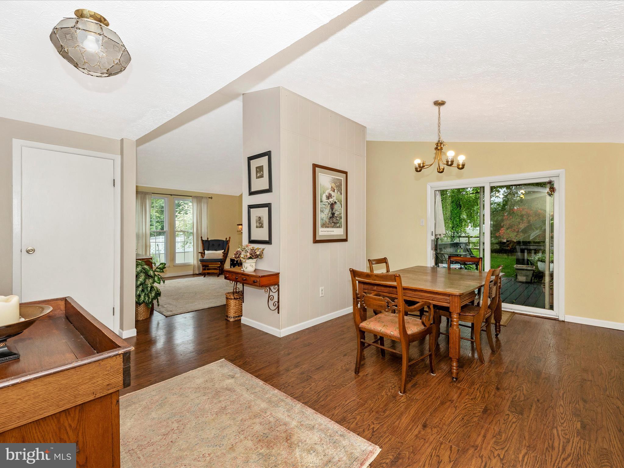 4310 Zircon Road Middletown, MD 21769 - Photo 5 of 86 a dining room with wooden floor a chandelier a wooden table and chairs