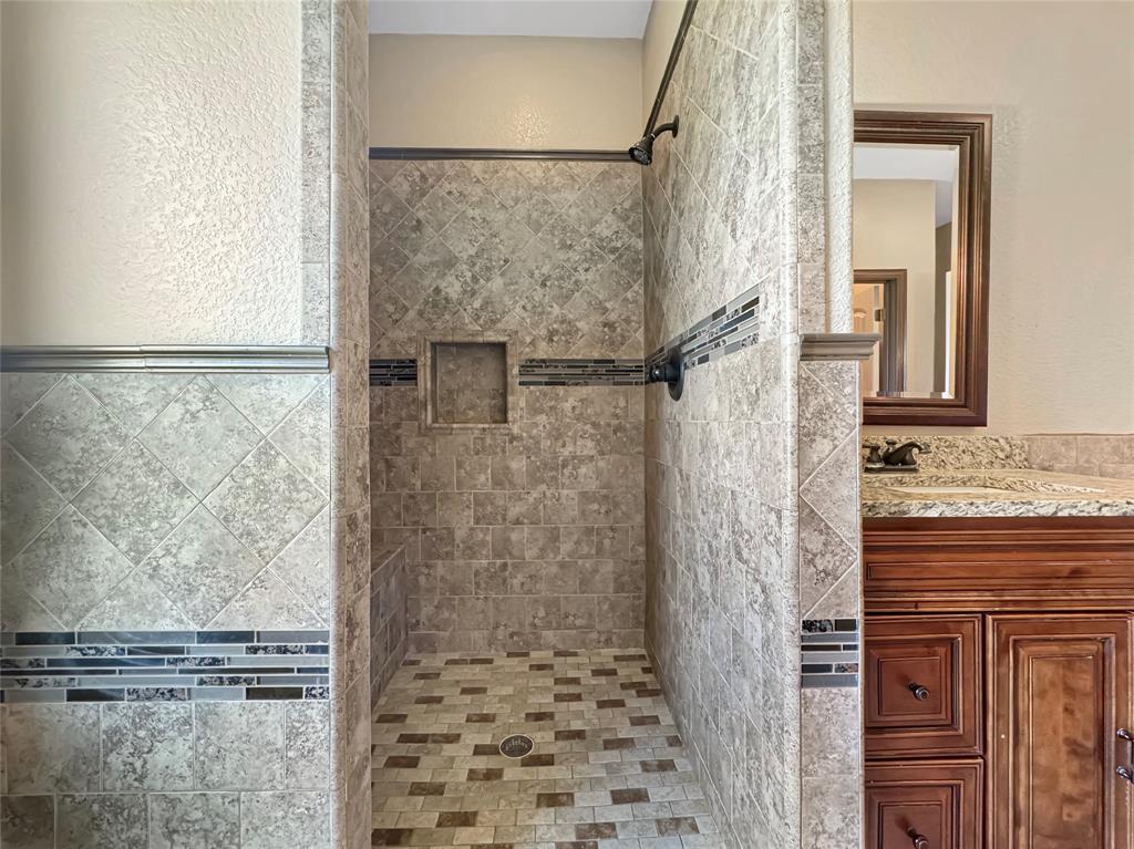 151 Crump Circle Red Oak, TX 75154 - Photo 13 of 21 Bathroom with a textured wall, a shower stall, and vanity