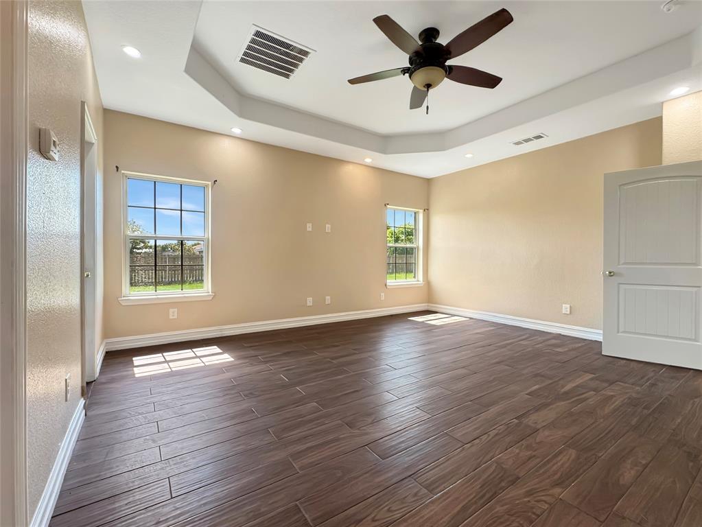 151 Crump Circle Red Oak, TX 75154 - Photo 17 of 21 Unfurnished room with wood tiled floors, a raised ceiling, ceiling fan, and recessed lighting