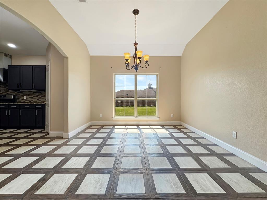 151 Crump Circle Red Oak, TX 75154 - Photo 4 of 21 Unfurnished dining area featuring arched walkways, lofted ceiling, and a chandelier