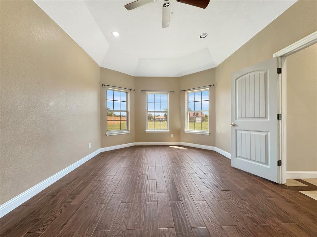 151 Crump Circle Red Oak, TX 75154 - Photo 6 of 21 Empty room featuring dark wood-type flooring, a textured wall, ceiling fan, and recessed lighting