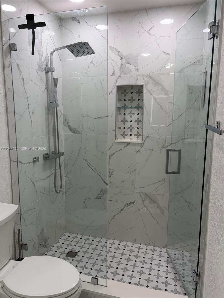 11956 Southwest 209th Street Miami, FL 33177 - Photo 11 of 14 a bathroom with a toilet and a shower