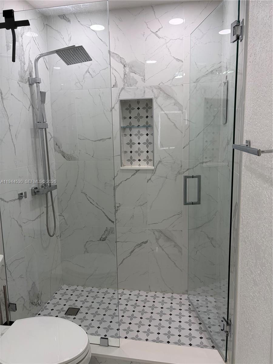 11956 Southwest 209th Street Miami, FL 33177 - Photo 12 of 14 a bathroom with a shower a toilet and a shower