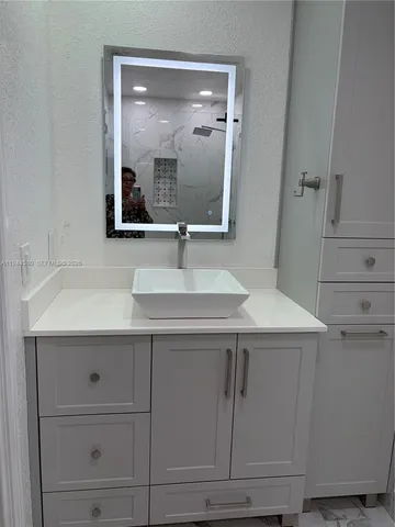 a bathroom with a sink and a mirror