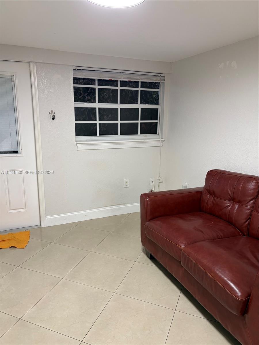 11956 Southwest 209th Street Miami, FL 33177 - Photo 4 of 14 a living room with a couch and a table