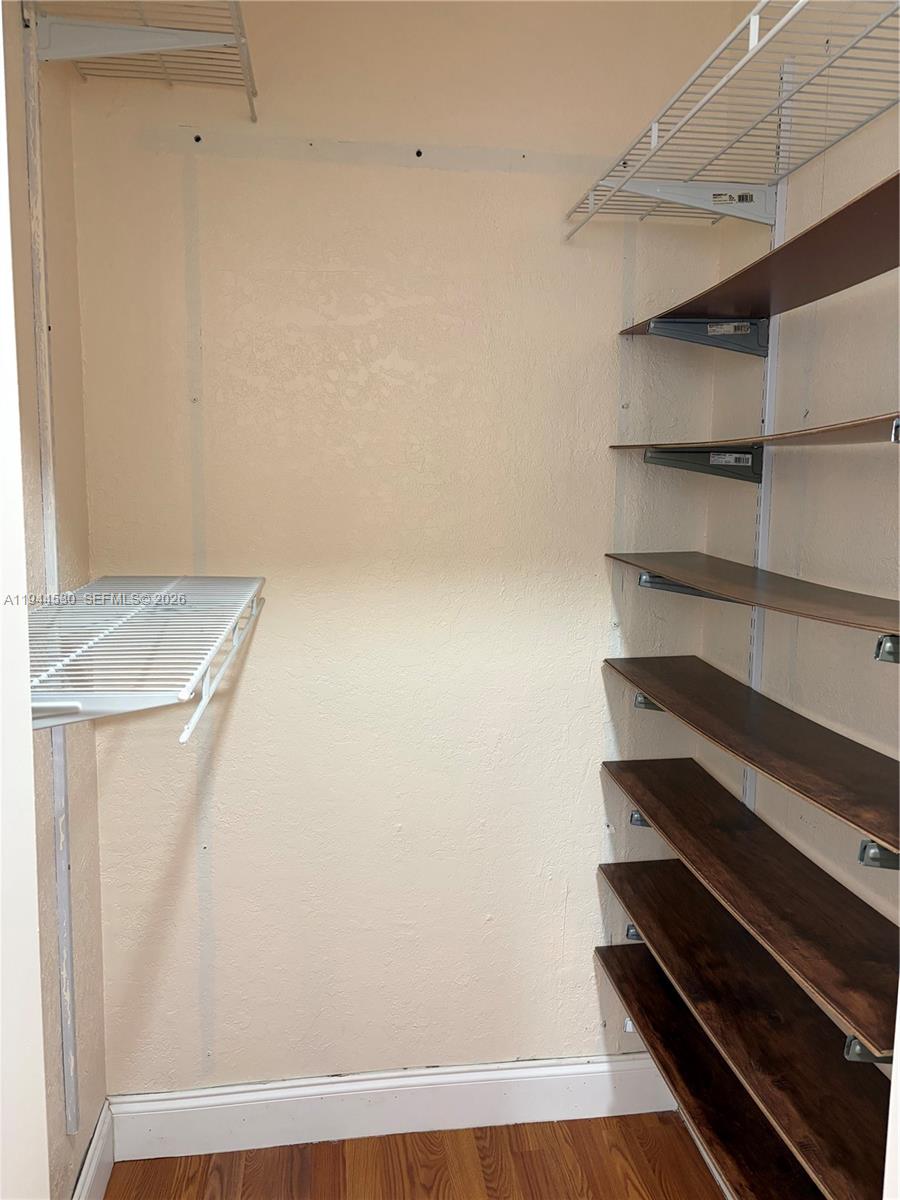 11956 Southwest 209th Street Miami, FL 33177 - Photo 10 of 14 a view of room with racks on the wall