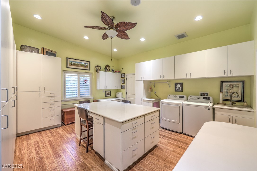 3910 West Pebble Road Las Vegas, NV 89139 - Photo 25 of 59 Laundry room featuring light wood finished floors, ceiling fan, recessed lighting, and separate washer and dryer, and lots of storage