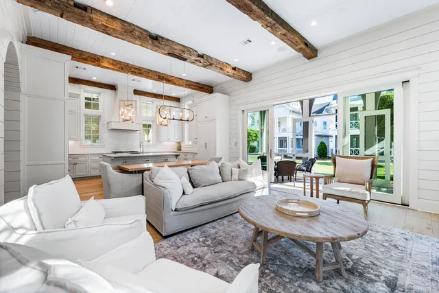 a kitchen with a table chairs sink and cabinets