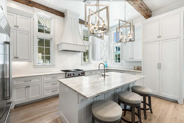 a kitchen with stainless steel appliances a sink stove and cabinets