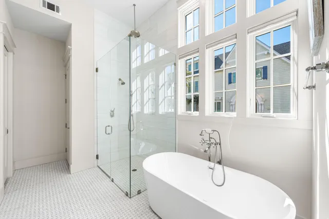 a bathroom with a tub shower and sink
