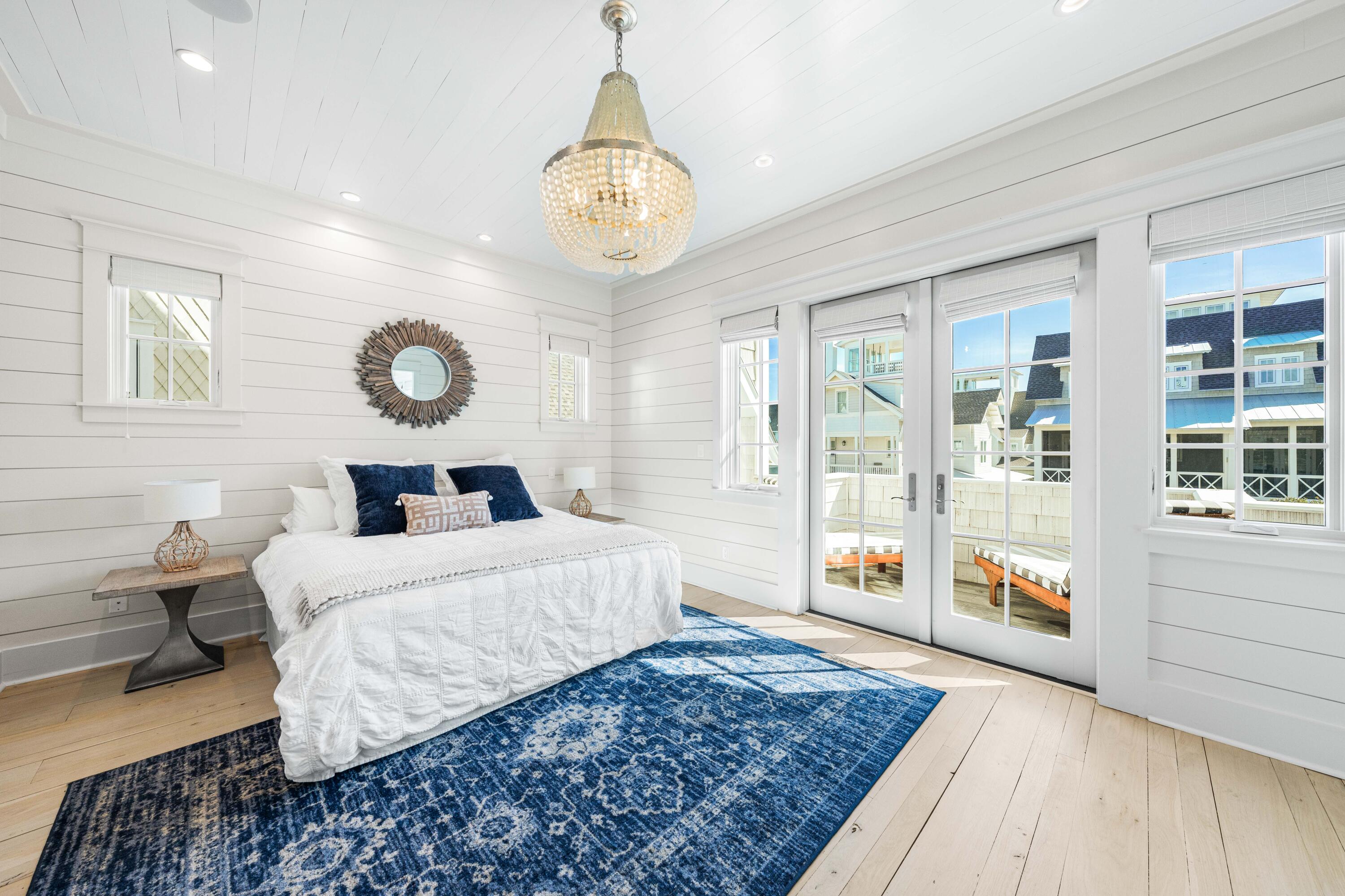 10 Rainer Ln Inlet Beach Inlet Beach, FL 32461 - Photo 26 of 55 a bedroom with a large bed and a chandelier