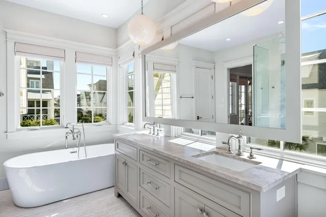 a bedroom with a bed ceiling fan and a large window