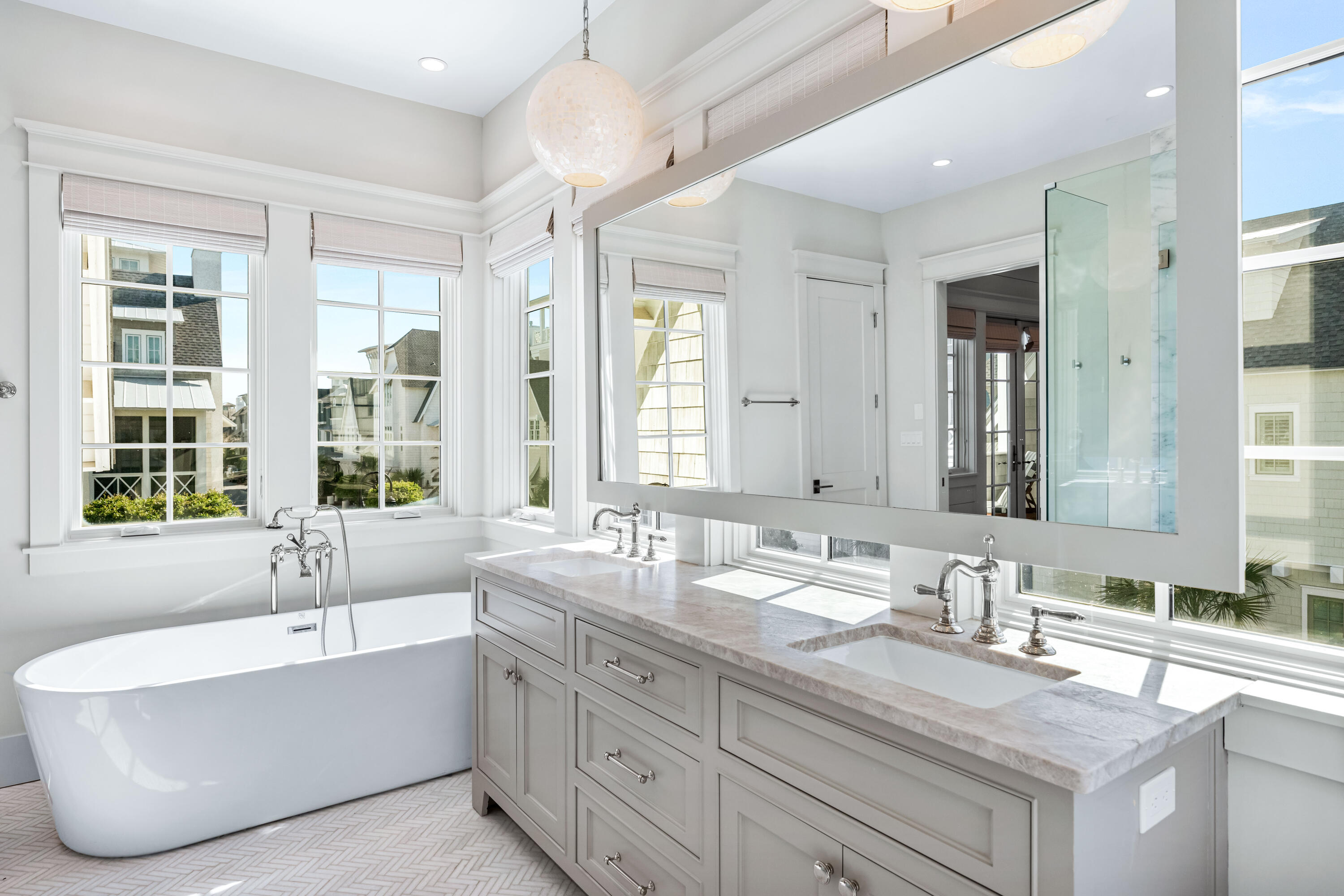 10 Rainer Ln Inlet Beach Inlet Beach, FL 32461 - Photo 30 of 55 a bathroom with double vanity sinks a large mirror and a bathtub