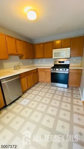 a view of kitchen cabinets and wooden floor
